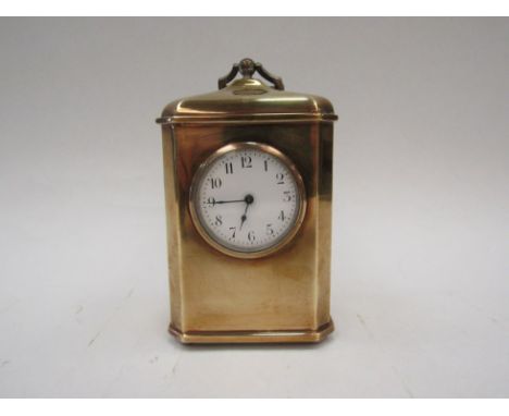 A brass carriage clock with Arabic chapter ring. Raised on ball feet. 11.5cm high 