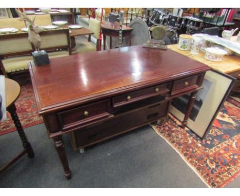 A Victorian style writing table of three faux and three frieze drawers on turned and carved legs. 78cm x 148cm x 83cm 