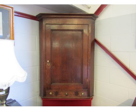 A Georgian oak corner cupboard with three drawers. 114cm high x 86cm wide 