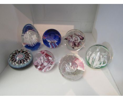 Seven various glass paperweights including Caithness, Golden Jubilee and Langham glass 