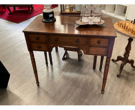 A Victorian mahogany writing table, five frieze drawers, turned legs, one knob missing, 78cm tall x 85.5cm wide x 46cm deep 