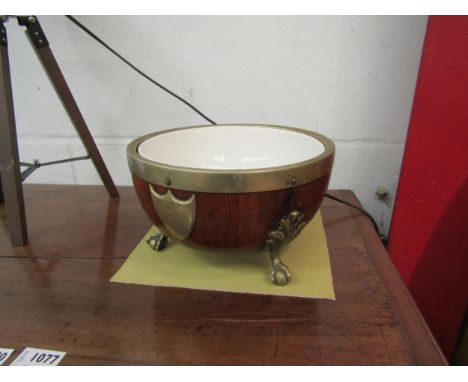 A 19th Century oak metal bound bowl raised on ball and claw feet with ceramic liner, engraved shield cartouche, 23.5cm diamet