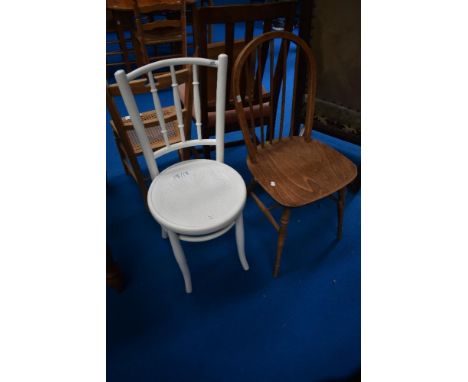 A traditional painted bentwood chair and a hoop and stick back dining chair