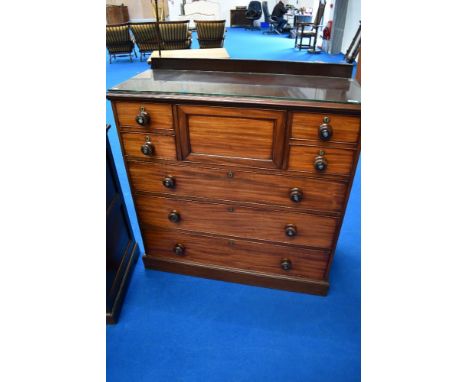 A Victorian mahogany 'Scotch' chest of drawers, having concealed central drawer flanked by two short drawers to each side and