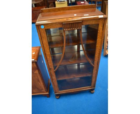 A mid 20th Century oak display cabinet of compact proportions