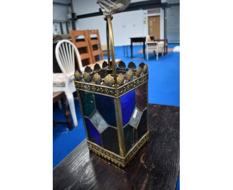 A vintage brass and coloured glass lantern style ceiling light fitting