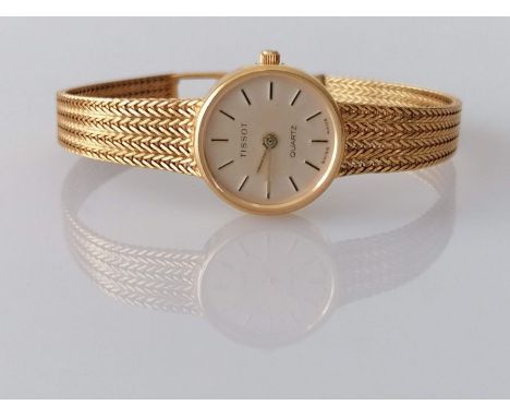 A Tissot ladies quartz watch with baton markers, champagne dial 15mm, herringbone woven 9ct gold strap with adjustable clasp,