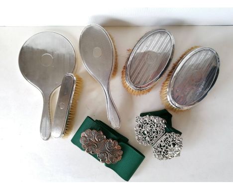 An Edwardian silver nurse's buckle with profuse pierced decoration, hallmarked for E S Barnsley &amp; Co., 1908; another copp