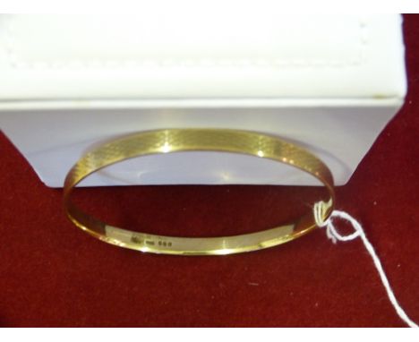 A 9ct gold slave bangle Edinburgh 1925, with engine turned decoration, 24gms 