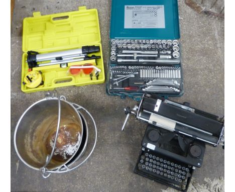 A pair of stainless steel buckets, an Imperial manual typewriter, an unused Kamasa 124 piece socket and spanner set and a cas