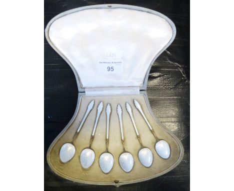 An Edwardian silver gilt and enamel set of six teaspoons, London import 1901, with guilloche enamel bowl and handle, case