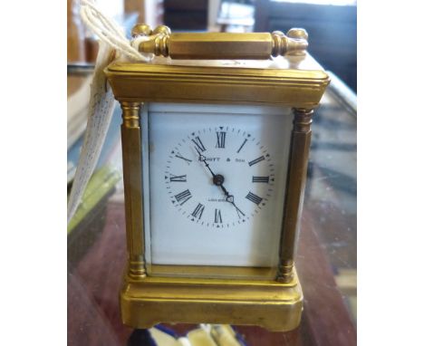 A brass carriage clock with keywind movement, the enamel dial inscribed "Elliott and Son London", 11cm high