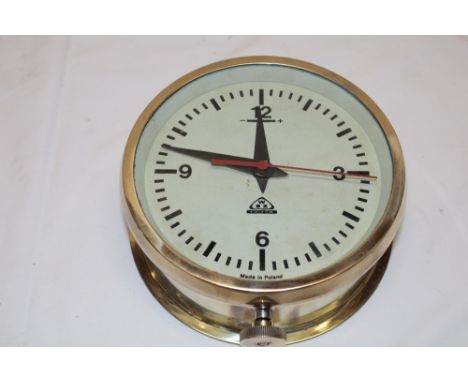 A Polish nautical wall clock with painted circular dial in brass cylindrical case