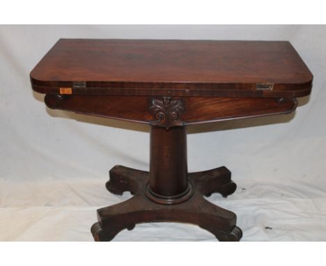 A Victorian mahogany rectangular turnover top card table with baize lined playing surface on turned column with plateaux base