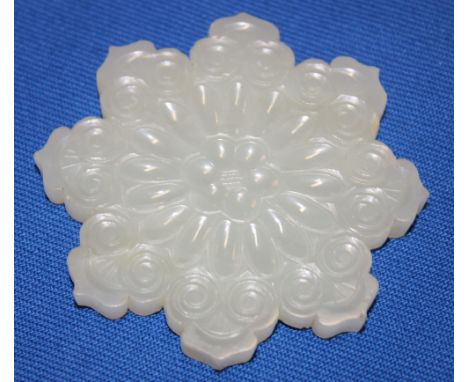 A good quality Chinese jade belt ornament in the form of a flower, carved on both sides, 2½" diameter