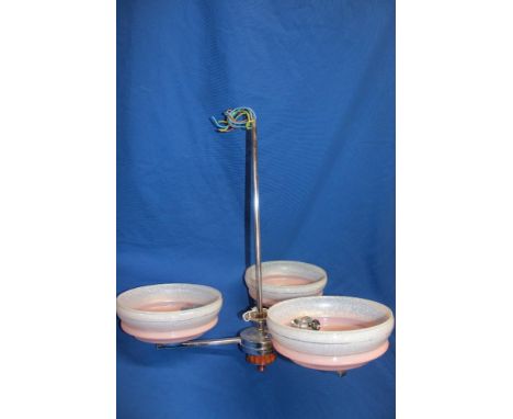 A 1930's Art Deco three branch chromium-plated chandelier with butterscotch ribbed trim supporting three pink-tinted glass up