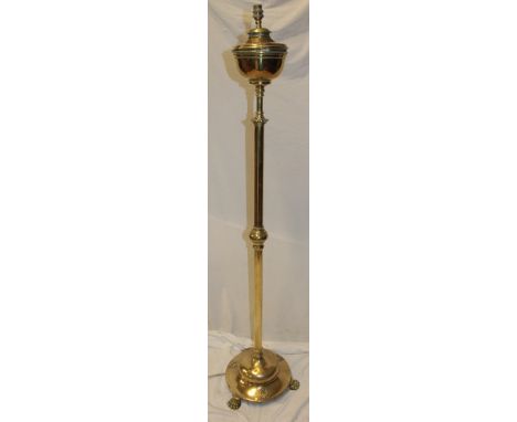 A good quality brass rise-and-fall oil lamp standard with circular font on circular base with paw feet