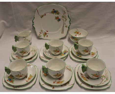 A Royal Albert Crown China tea set with floral decoration comprising six tea cups with ornate butterfly wing handles, six sau