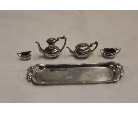 A good quality silver miniature tea and coffee set comprising classical-shaped coffee pot with angular handle, 2" long, match