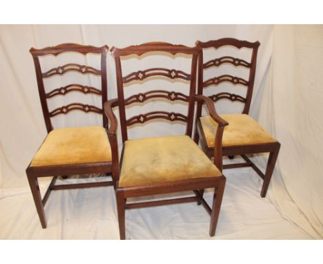 A set of four single and one carver reproduction mahogany Chippendale-style dining chairs with pierced rail backs and upholst