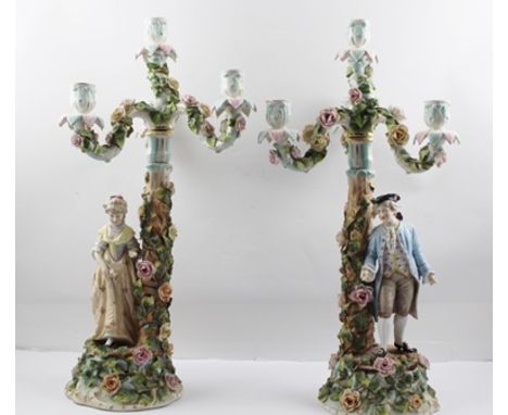 A PAIR OF LATE 19TH CENTURY SITZENDORF PORCELAIN FIGURAL CANDELABRAS, the floral encrusted bases and stands mounted with figu