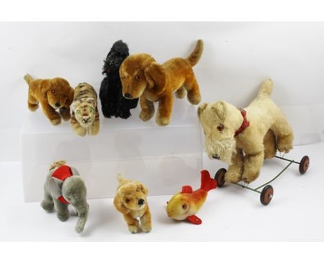 A COLLECTION OF EIGHT STEIFF ANIMALS, to include tiger, goldfish, elephant, dogs (8) 