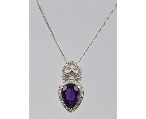 A WHITE GOLD AMETHYST AND DIAMOND NECKLACE, having clover leaf encrusted with diamonds above an inverted pear shaped large am