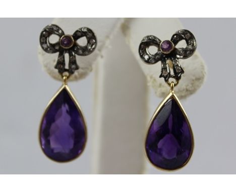 A PAIR OF AMETHYST AND DIAMOND DROP EARRINGS, having diamond set bow with central small circular amethyst, above pear shaped 