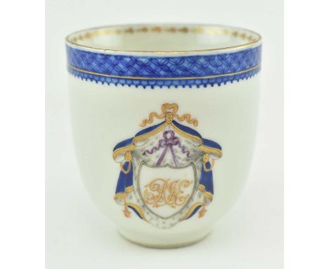 A Chinese hand painted porcelain armorial Samsom style teacup. The teacup with gilt rim, blue border, relief foliate shape to