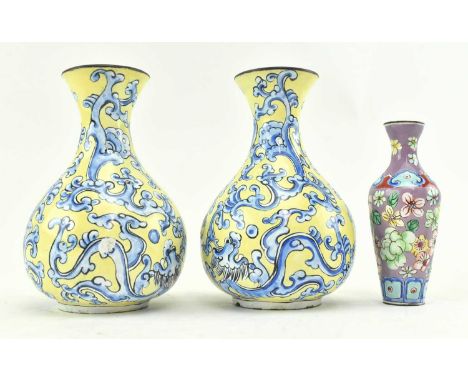 A pair of small Chinese enamel cloisonne hand painted vases, and another miniature example. The lot comprising a pair of blue