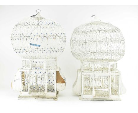 A pair of vintage mid century French style white painted toleware bird cages. Each with wire worked design &amp; moveable doo