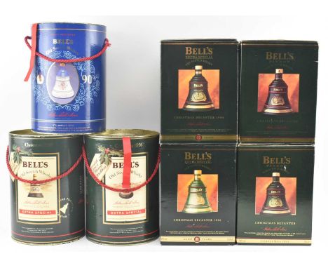 A collection of vintage Christmas Bell's Whisky porcelain decanter bottles in original boxes. The lot to include year 1990 to