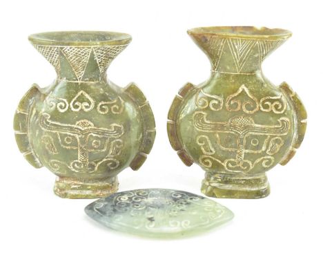 A pair of hand carved believed Chinese jadeite hardstone temple vases, along with a similar jadeite amulet. Each featuring ha