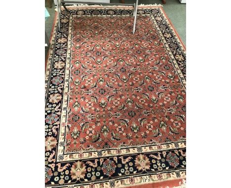 Persian style carpet rust ground with stylized floral decoration