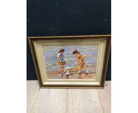 A gilt framed oil painting portrait of 2 girls on a seashore with toy sail boats, 30x40cm
