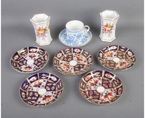 A collection of Royal Crown Derby ceramics to include five saucers in the 2451 pattern, two Derby Posies vases and blue and w