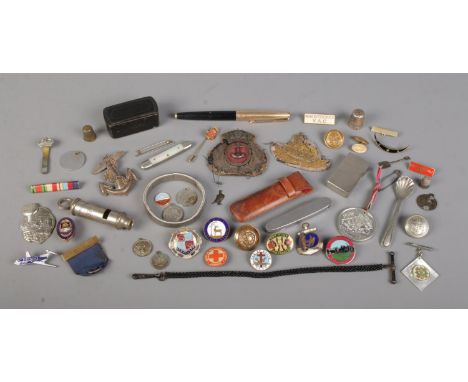 A box containing an assortment of collectables, to include 'The Metropolitan' whistle, a collection of military buttons and b