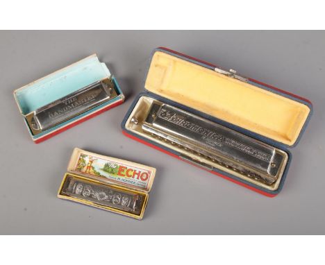 A collection of vintage harmonicas including a Hohner Echo Super Vamper, The 64 Chromonica and The Bandmaster  