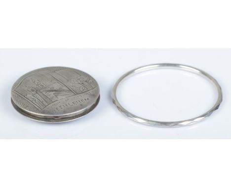 An 833 silver powder compact bearing Church of Nativity Bethlehem scene, together with a Sterling silver bangle with geometri