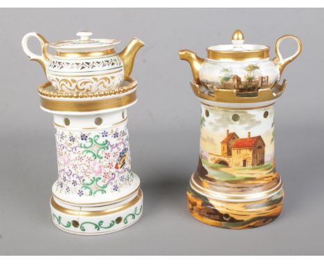 Two hand painted ceramic three part Veilleuse teapot warmers one featuring decorative rural village landscape and the other f