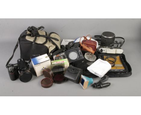 A Nikon Coolpix 8800 camera together with an assortment of photographic accessories  