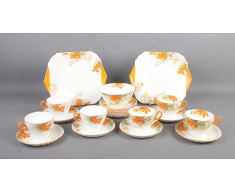 A Shelley six place ceramic tea service, in the Winter Cherry pattern. Contains cup and saucers, sugar bowl and side plates. 