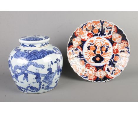 A large blue and white oriental lidded vase of bulbous form depicting children playing along with an Imari plate. Vase bearin
