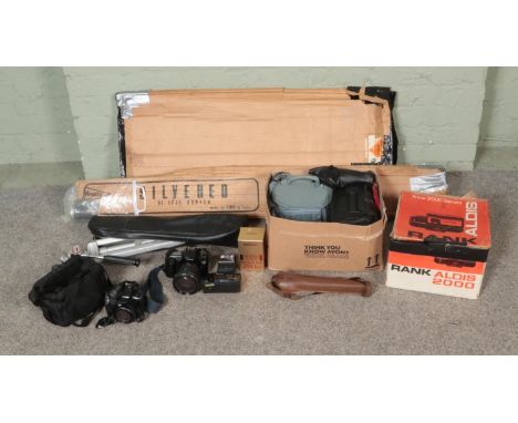 A box of assorted cameras and accessories to include Canon Powershot SX10IS, EOS 100F, tripods, projector, etc.  