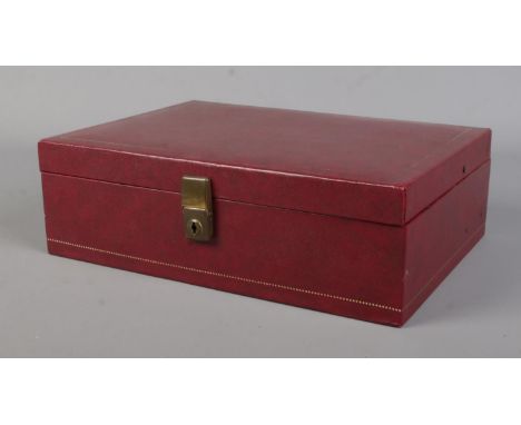 A deep red cantilever jewellery box containing costume jewellery. Includes belt buckle, brooches, large cameos, bracelets, be