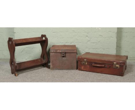 A vintage leather suitcase, with GMC embossed initials, together with a book trough and vintage twin handled tin trunk.  