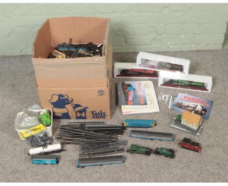 A box of assorted model railway carriages, track and accessories to include three boxed Atlas Edition display locomotives, ki