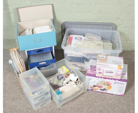 A large quantity of crafting and card making materials including various tools, papers, stamps, Gemini machines including die