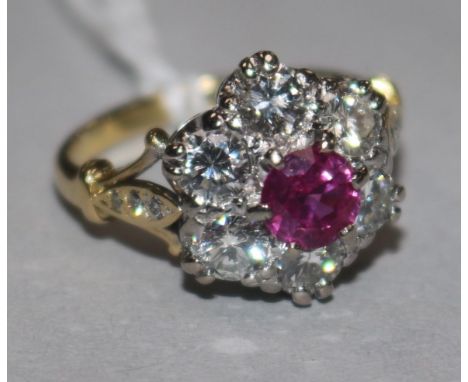 A Victorian style 18ct gold, ruby and diamond cluster ring, with diamond set shoulders, size K.