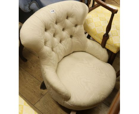 A Victorian button-back sewing chair, upholstered in ivory fabric, on turned legs